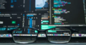 A blurred laptop screen with programming code and AI tools, symbolizing artificial intelligence in online shopping.