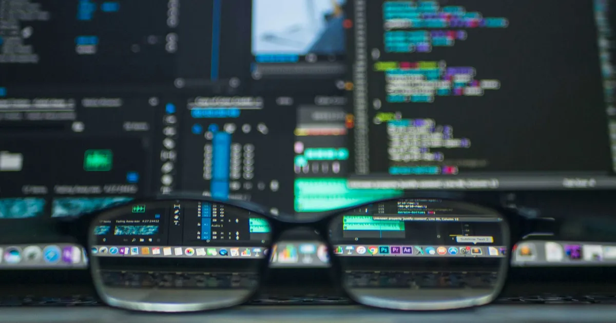 A blurred laptop screen with programming code and AI tools, symbolizing artificial intelligence in online shopping.